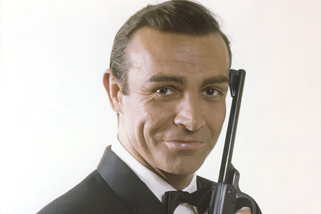 Sean Connery holding a gun as James Bond