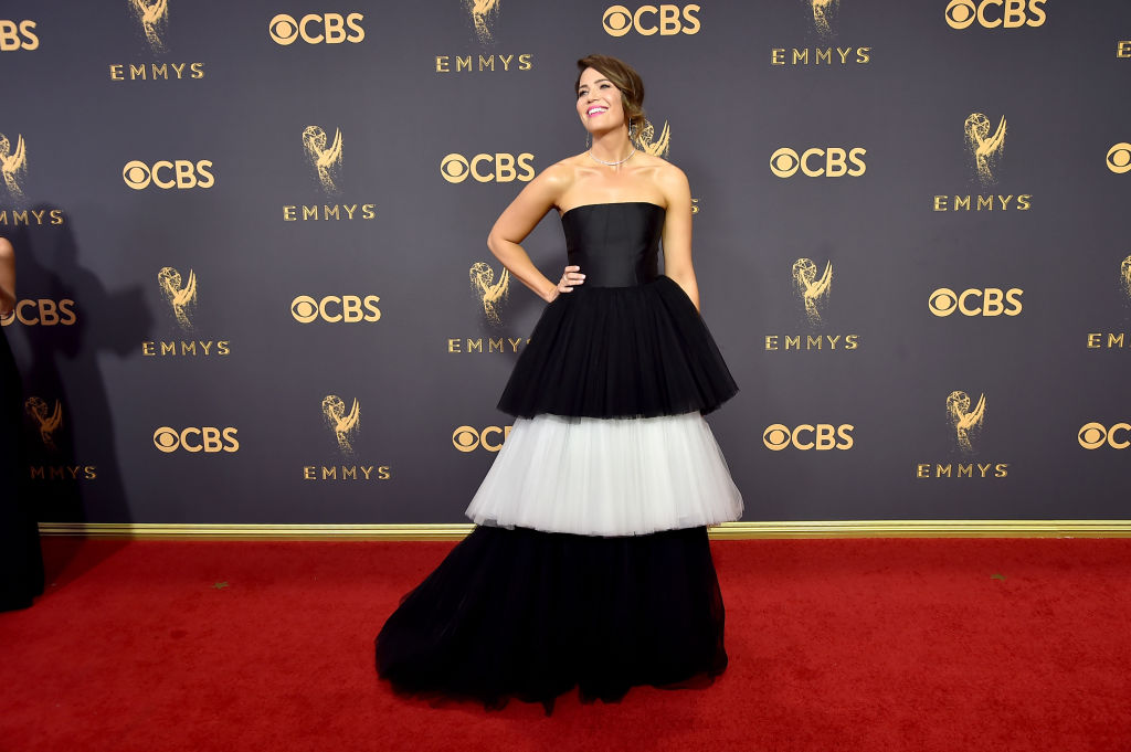 Mandy Moore wears a black and off-white, layered gown.