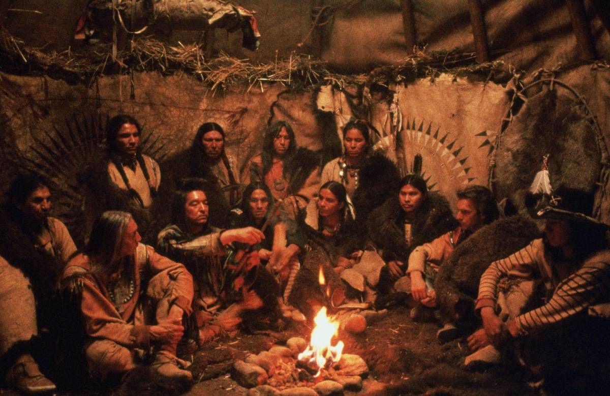 Actors sitting around a fire