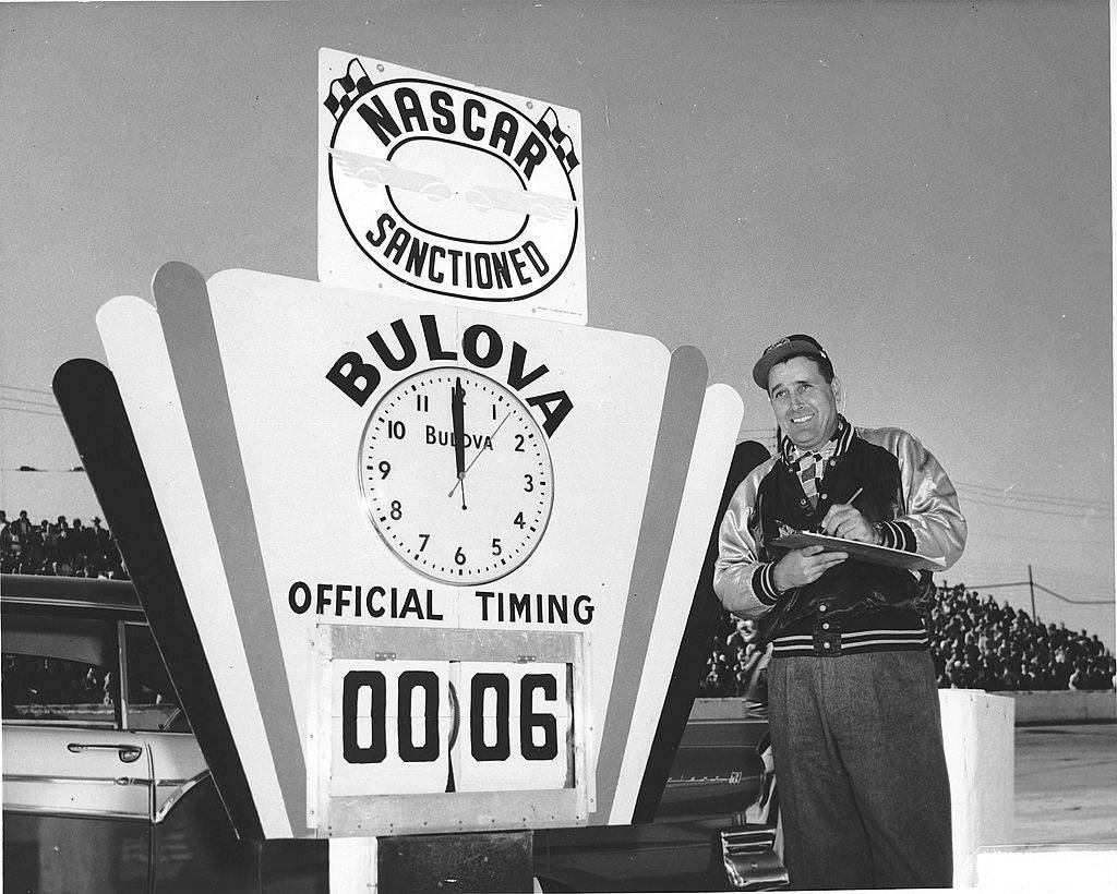 Man standing next to sign