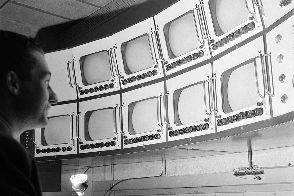 Man looking at screens