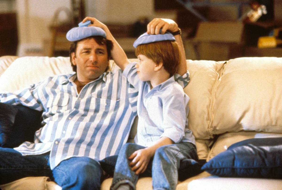 dad and son putting ice packs on each other's heads in problem child