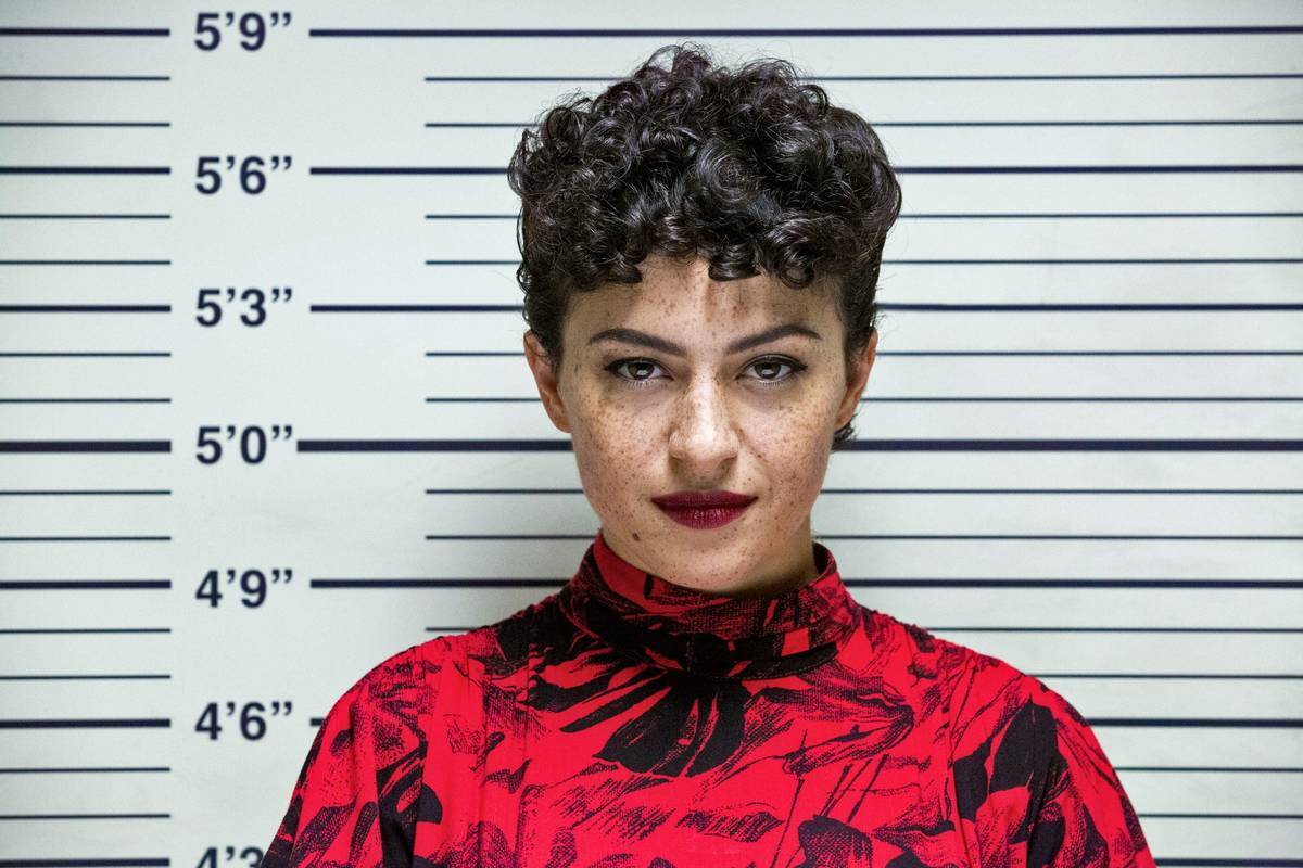 Alia Shawkat standing at a line-up in search party