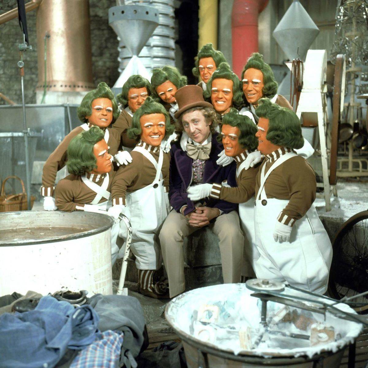 Gene Wilder as Willy Wonka surrounded by Oompa Loompas