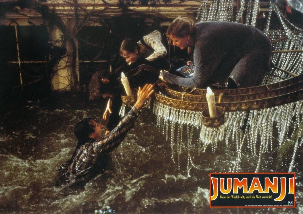 Family on chandelier while living room floods, still from movie Jumanji