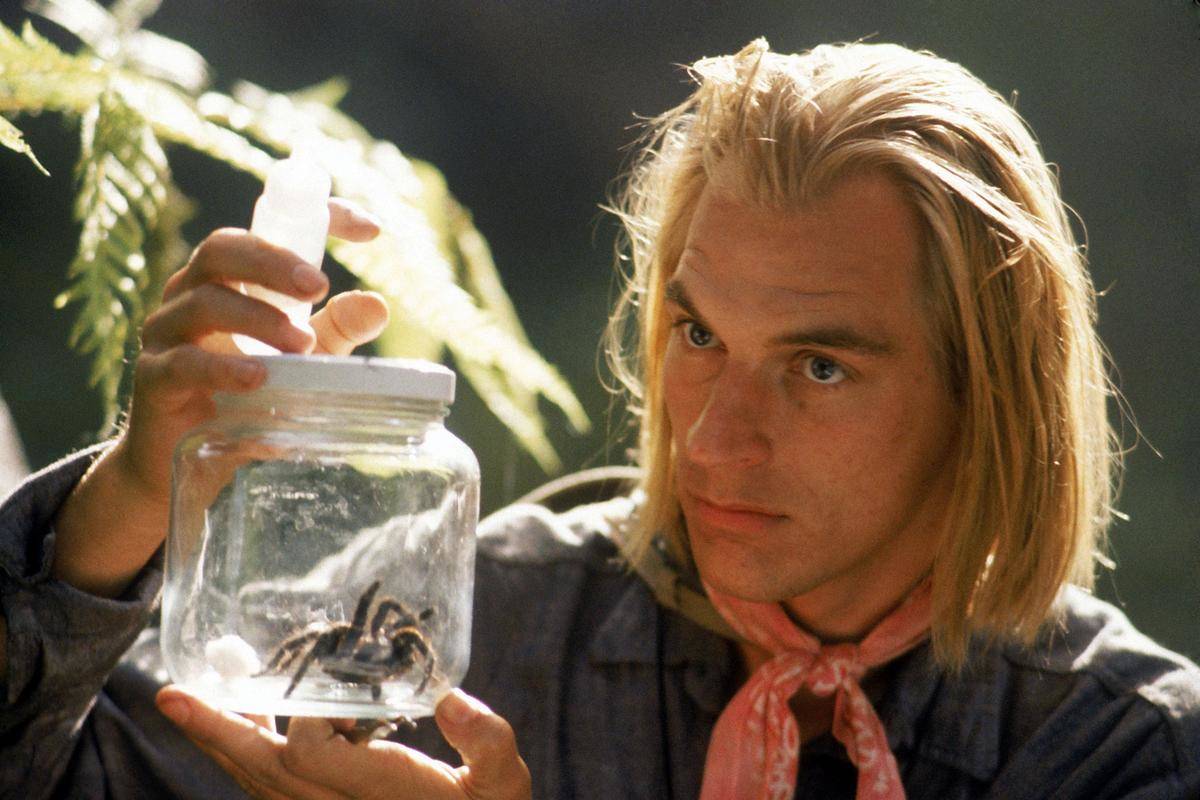Still image from Arachnophobia movie (1990) of man holding a jar with a spider in it