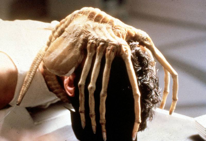 Scene still from Alien movie of the alien covering her head