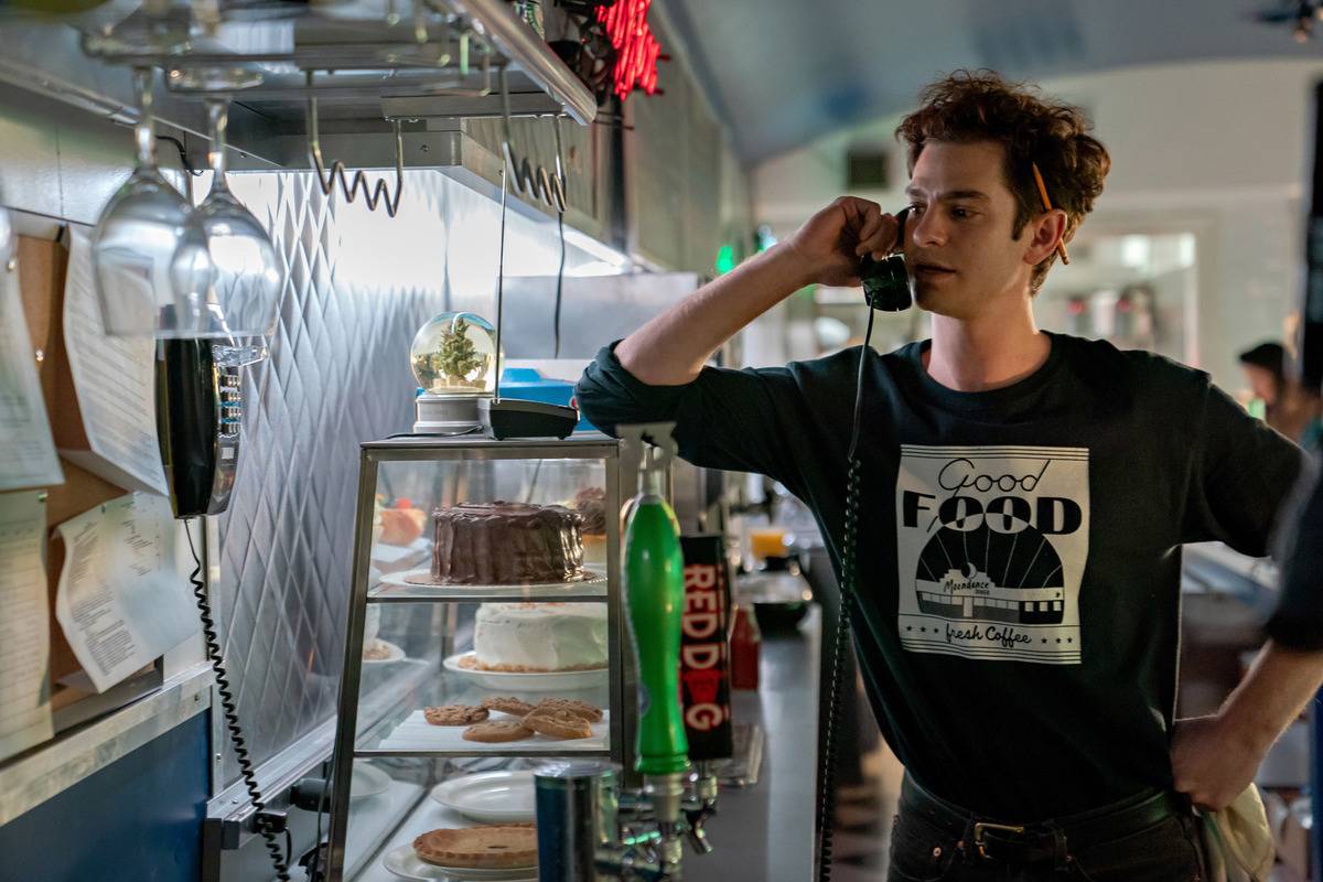andrew garfield on the phone at the diner