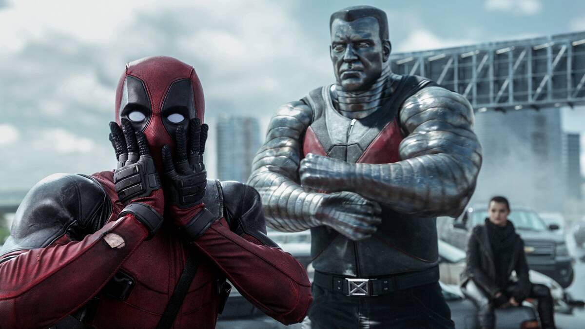 Deadpool staring at the camera in exaggerated shock while Collossus looks on