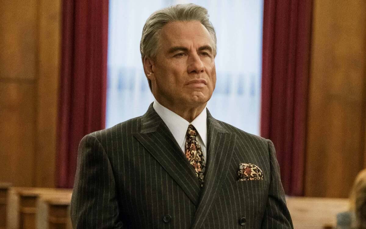 John Travolta standing in suit as John Gotti