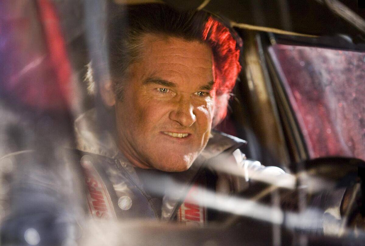 Kurt Russell driving with evil facial expression as Stuntman Mike in Death Proof