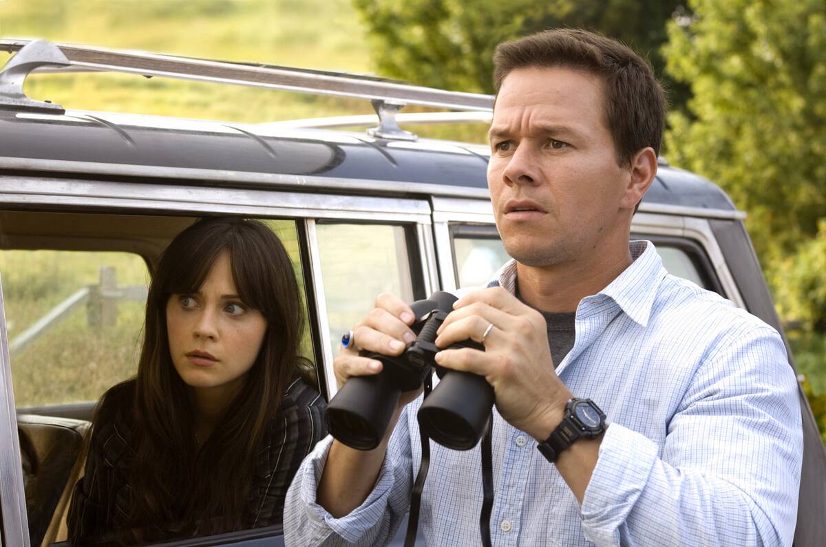 Mark Wahlberg and Zooey Deschanel looking shocked with car and binoculars as Elliot and Alma Moore in The Happening