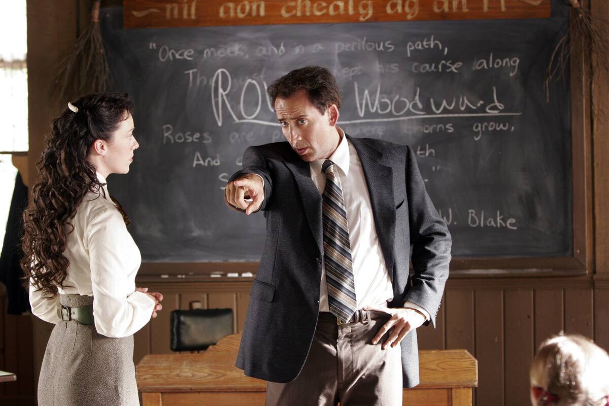 Nicolas Cage pointing in classroom as Edward Malus while Moly Parker looks on in The Wicker Man