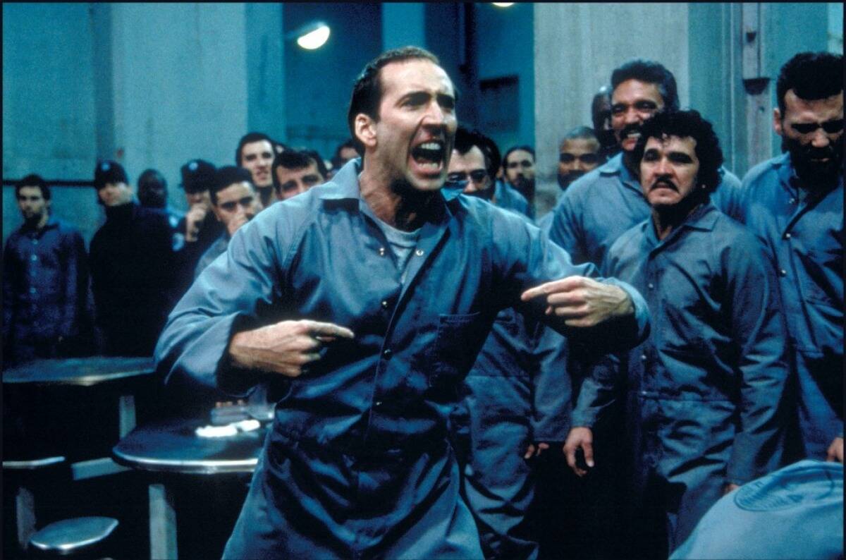 Nicolas Cage screaming at prison inmates as Castor Troy in Face Off