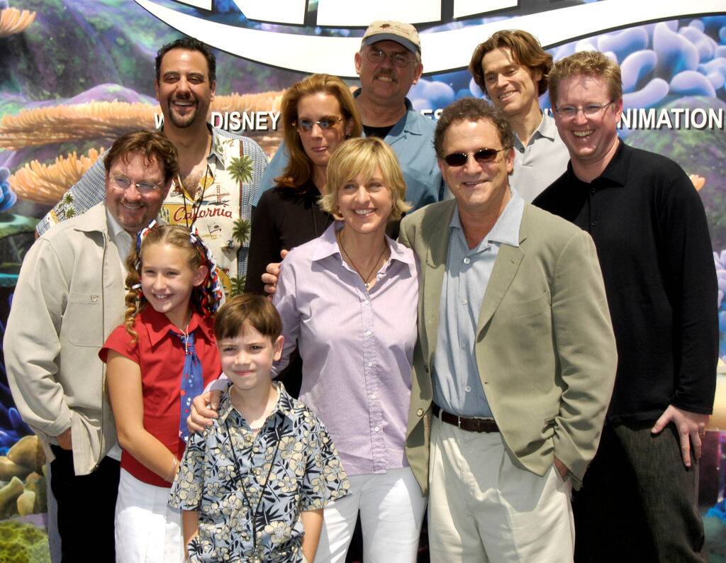 people posing on a red carpet