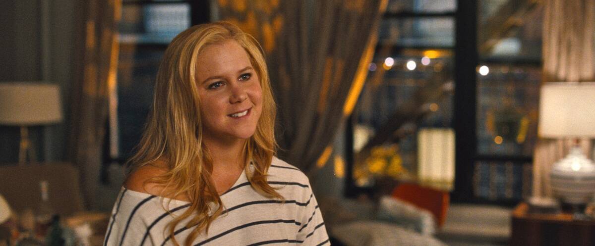 Amy Schumer smiling as Amy Townsend in Trainwreck