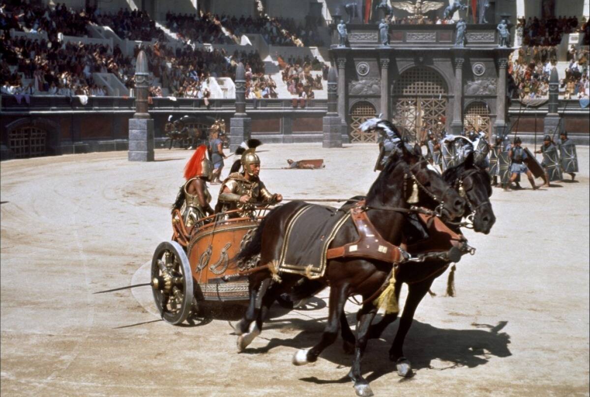Roman centurions driving horse-drawn chariot in Collosseum in Gladiator