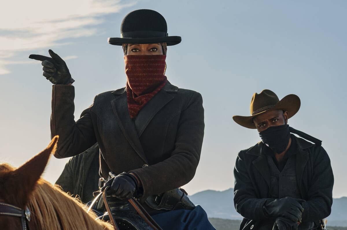 Regina King and Lakeith Stanfield wear bandit bandannas on horseback in The Harder They Fall