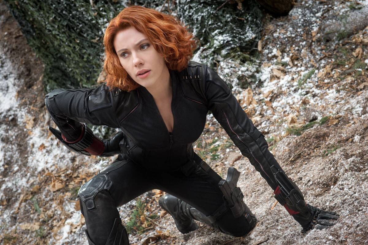 woman with red hair and black suit
