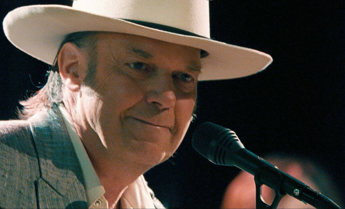 neil young performing on stage in heart of gold