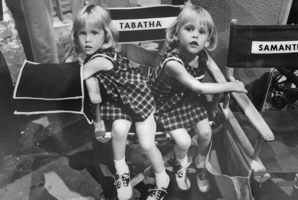Young Twin Sisters Sitting on Chair